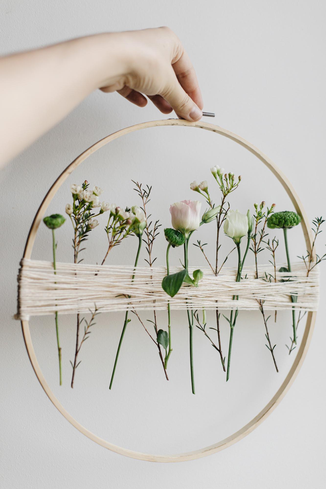 Hand-stitched floral hoop in studio